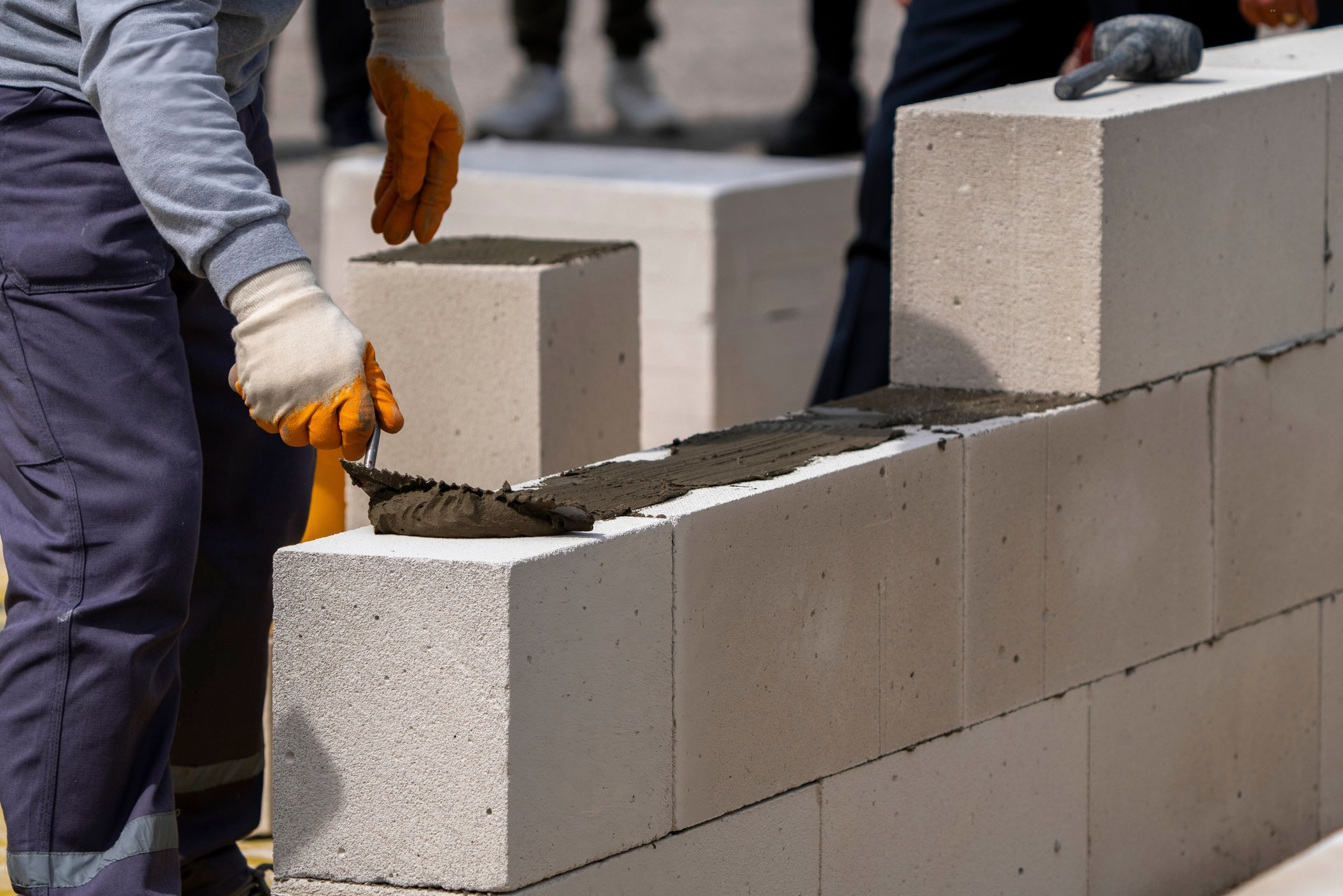 The bricklayer is working. Building a wall of aerated concrete. Gasbeton wall